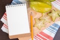 Star apple or averrhoa carambola and notebook on wooden block.