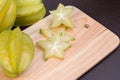 Star apple and averrhoa carambola on wooden block. Fresh star apple fruit on wood table. Royalty Free Stock Photo