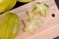 Star apple and averrhoa carambola on wooden block. Fresh star apple fruit on wood table. Royalty Free Stock Photo