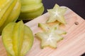 Star apple and averrhoa carambola on wooden block. Fresh star apple fruit on wood table.