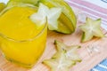 Star apple juice or averrhoa carambola squash on wooden block.