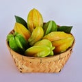 Star apples. Tropical fruits in bamboo basketwork Royalty Free Stock Photo