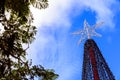 A star atop a Christmas tree, against the blue sky outdoors Royalty Free Stock Photo