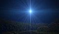 Star of Bethlehem, or Christmas Star over the night forest. A bright star indicates the Nativity of Jesus Christ in the starry sky Royalty Free Stock Photo