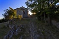 Star burst sun through trees with Provence Church