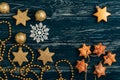 Star cookies, Christmas balls and a snowflake on an old wooden background. Royalty Free Stock Photo