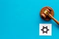 Star of David sign - religion Judaisim symbol - near gavel on blue table top view. Religious conflict concept. Copy