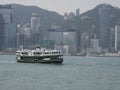 A Star Ferry sails across Victoria Harbour in Hong Kong Royalty Free Stock Photo