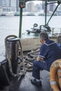 Star Ferry staff sits as the boat crosses Victoria Harbour in Hong Kong Royalty Free Stock Photo