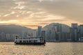 Star ferry in Victoria Harbor and HK skyline at sunrise. View from Kowloon on Hong Kong Royalty Free Stock Photo
