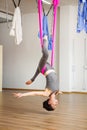 Star Inversion aerial antigravity yoga pose, woman exerciseses with hammock