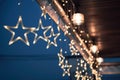 Star light bulb glowing and hanging on ceiling in Christmas Royalty Free Stock Photo