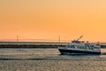 Star Line ferry leaving Mackinac Island harbor in front of the Mackinac Bridge at sunset Royalty Free Stock Photo