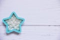 The star made of blue plastic with beads on a white background. Children`s toy on a wooden white table Royalty Free Stock Photo