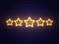 Star rating neon banner. Golden five stars on brick wall. Shining signboard. Night bright advertising. Vector