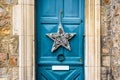 A star-shape Christmas decoration hanging on a blue front door Royalty Free Stock Photo