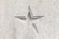 star shape detail carved into a concrete wall