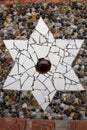 Star-shaped brick mosaic texture with the bottom of a bottle in the center