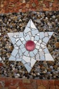 Star-shaped brick mosaic texture with the bottom of a bottle in the center