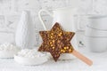 Star shaped chocolate lolly with gold sugar pearls