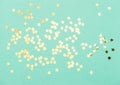Star shaped golden confetti mint color flat lay background