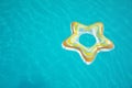 Star shaped inflatable ring floating in swimming pool on sunny day, above view Royalty Free Stock Photo