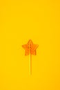 Star Shaped Lollipop on Yellow Background Homemade Fruit Lollipop Candy Background Flat Lay Top View Vertical Toned