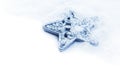 Star snowflake christmas decoration in white snow isolated