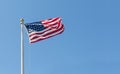 American flag on the blue sky background, turned to the right Royalty Free Stock Photo