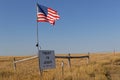 Star spangled banner flag and a message over the couuntryside of South Dakota