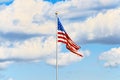 Star-striped American flag flutters proudly against the blue sky