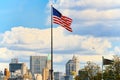 Star-striped American flag flutters proudly against the blue sky