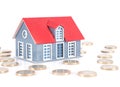 Star-studded euro coins and small house model on white background Royalty Free Stock Photo