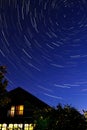 Star tracks , house, night sky background. Light Royalty Free Stock Photo