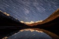 Star tracks mountains lake sky reflection Royalty Free Stock Photo