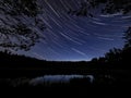 Star trails above the forest pond Royalty Free Stock Photo