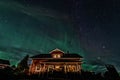 Star Trails and Aurora - Long exposure to capture star trails and light aurora borealis over Swedish countryside house, night