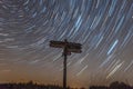 Star trails in the Bavarian Forest in front of a signpost with German place names of the theme hiking trail between Reichenberg an