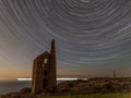 Star trails behind Wheal Owles tin mine on the Cornish coast Royalty Free Stock Photo