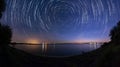 Star trails at the lake side panorama Royalty Free Stock Photo