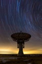 Star trails over radio telescope Royalty Free Stock Photo
