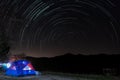 Star trails in night sky appear to circle the Polaris photographed from Sap Pa Wan Reservoir