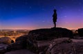 Star trails over boulders and statue on Little Round Top at nigh