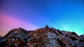 Star trails over the winter mountain landscape.