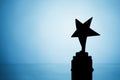 Star trophy silhouette, blue background