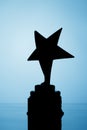 Star trophy silhouette, blue background