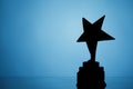 Star trophy silhouette, blue background