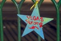 Star with Vegas Strong hashtag attached to a fence