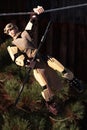 Star Wars action LEGO figure of Rey Skywalker in desert scavenger outfit, climbing on rope.