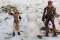 Star Wars LEGO action figures of Chewbacca and Rey Skywalker standing on half melted snow with cat like snowman